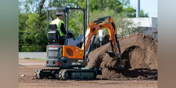 Develon Mini Excavator’s Retractable Undercarriage and Collapsible Dozer Blade Make It Slender